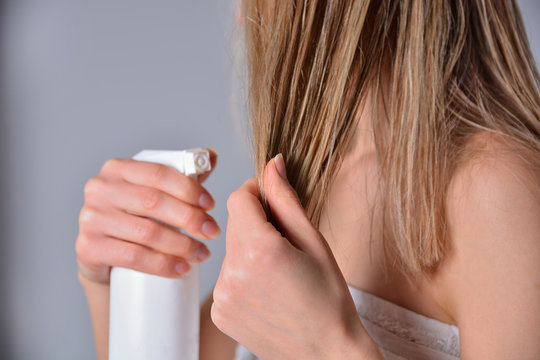 Blonde Shaggy Hair Woman Applying Hair Remedy From A Bottle At Home. Attractive Skinny Girl With Bare Shoulders. Cares About Healthy And Clean Hair. Beauty Salon Concept