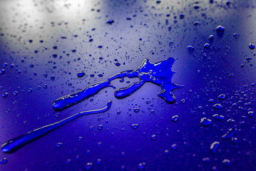 Water droplets on waterproof surface of the car vinyl film are blue purple. Texture