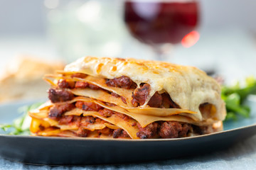 portion of lasagna with wine