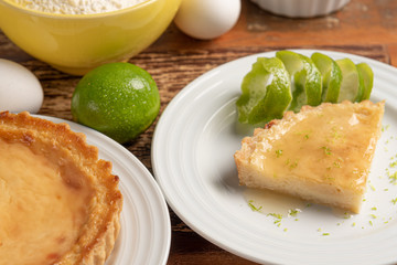 Homemade lemon pie with and a golden crust, on wooden background