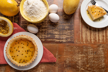 Homemade passion fruit pie with and a golden crust, on wooden background