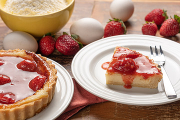 Homemade strawberry pie with and a golden crust, on wooden background