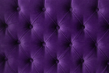 Quilted velour buttoned purple violet color fabric wall pattern background. Elegant vintage luxury...
