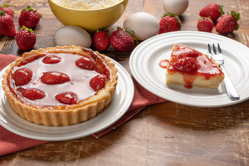 Homemade strawberry pie with and a golden crust, on wooden background