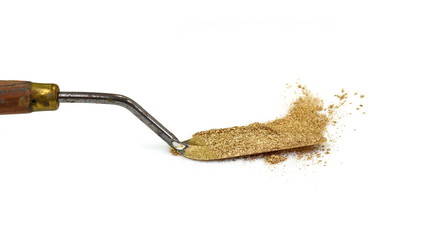 gold glitter powder on white background