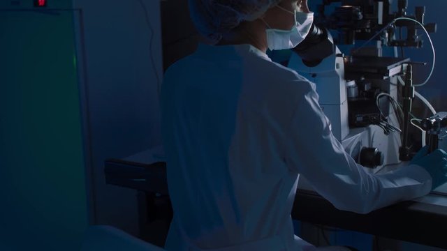 In a Modern Laboratory Scientist Conduct Experiments. The embryologist Examines Samples with a Microscope