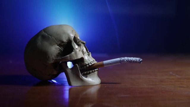No smoking concept. Creative artwork table decoration with cigarettes. Cigarettes cause cancer and kill. still life skull and sigarette. Selective focus