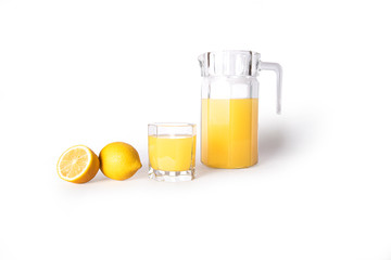 Jar of lemon juice with lemons isolated on a white background