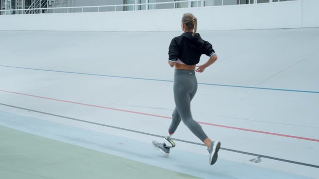 Woman with artificial limb jogging on track. Athlete running on sport stadium