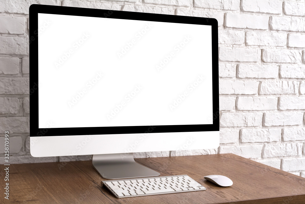 Wall mural mock up blank screen computer desktop with keyboard and mouse on wooden table.