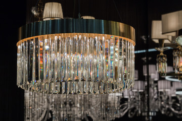 Close up on the crystal of round chandelier. Beautiful glass crystals