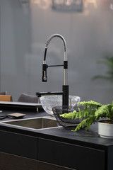 Modern kitchen faucet with remote hose, faucet with pull-out spout. Kitchen in black design