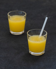 Orange juice in a glass on a dark background