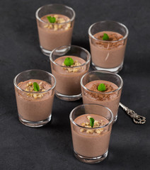  Chocolate nut jelly in a glass on a dark background