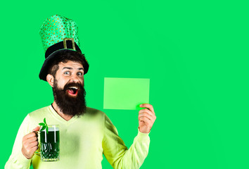 Saint Patrick's Day symbols. Bearded man in green hat holds green board. St Patrick's Day. Happy four leafed clover. Green hat with clover. Patricks Day green shamrock. Ireland tradition.