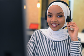 Female Customer Service Representative Answer Client's Questions in a Headset. Multi-Ethnic Team of...