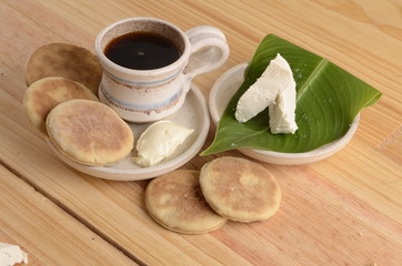 arepa de trigo venezolana con queso cuajado y taza de café caliente