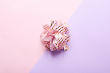 Packaging gift bow in center on colorful background