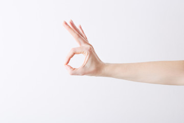 Empty female hand making gesture like OK on white background.