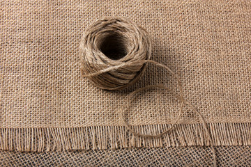 Linen rope roll and natural linen fabric texture.