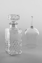 Isolated transparent empty glass botle and a glass