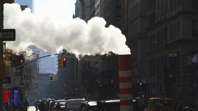 Steam rises and drifts among the rows of Fifth Avenue buildings in the wintertime at Midtown Manhattan New York City NY USA on Dec. 26 2018.