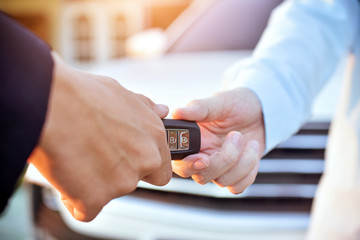 Salesman giving key car to customer,Car sale concept