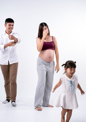 Obraz premium The beautiful pregnant woman and famly,husband and daughter,Happy emotion