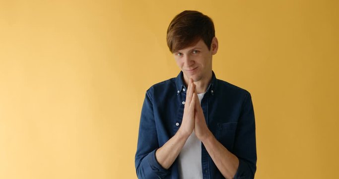 a man has a plan, a cunning guy, a man is plotting something, standing on a yellow background