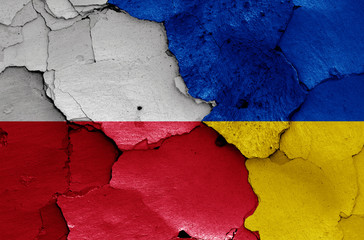 flags of Poland and Ukraine painted on cracked wall