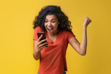 Portrait of attractive young african american girl using mobile phone