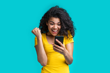 Portrait of attractive young african american girl using mobile phone