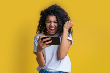 Portrait of attractive young african american girl using mobile phone