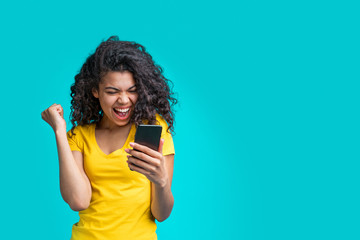 Portrait of attractive young african american girl using mobile phone - 325896971