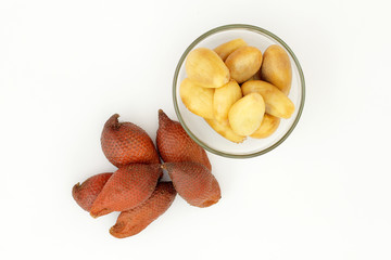 Salak fruit, Salacca zalacca or Snake fruits in the glass bowl an isolated on the white background.The fruit is sour. fruit peel with white background.