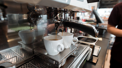 black coffee in white cup on coffee maker