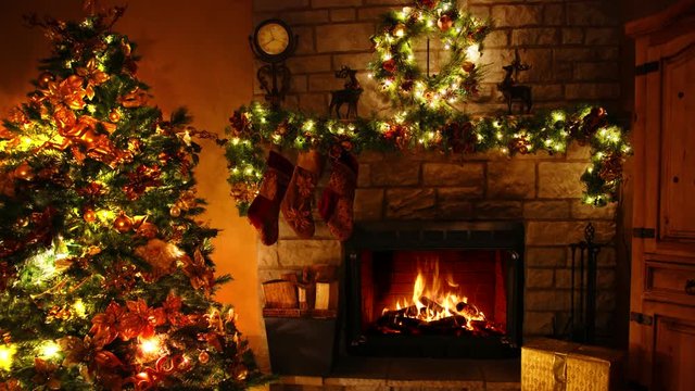 Beautiful 4k shot of firewood flame burning fireplace loop in cosy festive Christmas tree New Year decoration Noel room