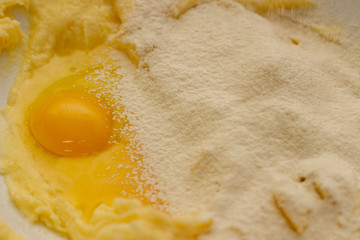 Egg yolk in flour with sugar. Baking dough for shortbread