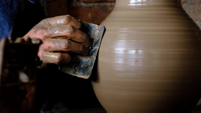 Potter hands working with mud