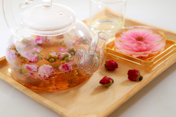 Roses tea with rose buds on white baackground