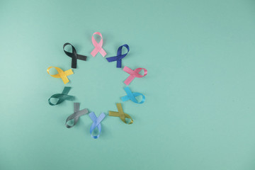 Close up of cancer ribbons on  mint background. Cancer awareness month.