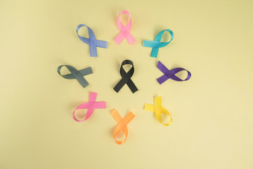 Close up of cancer ribbons on  yellow background. Cancer awareness month.