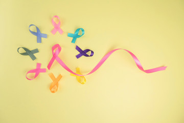 Close up of cancer ribbons on  yellow background. Cancer awareness month.