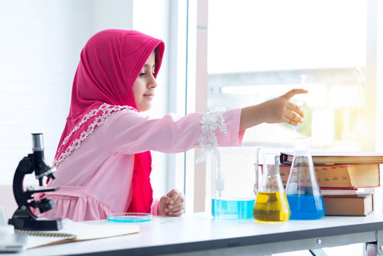 Asian muslim little girl doing a chemical experiment in laboratory at school, kids in science lab
