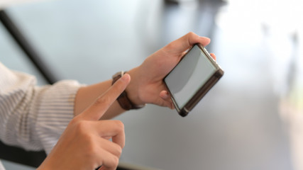 Close up view of businessman touching on horizontal smartphone