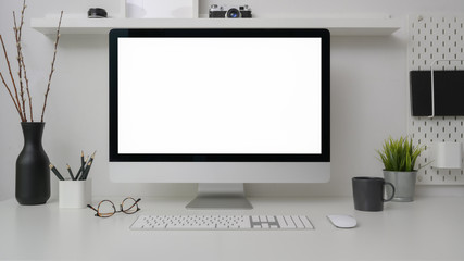 Close up view of simple workspace with blank screen computer, decorations and copy space