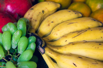 Green grapes, banana, oranges and pomegranate fruit together. Use for fruit concept.