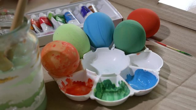 people using watercolor painting design on egg preparation for happy easter celebration