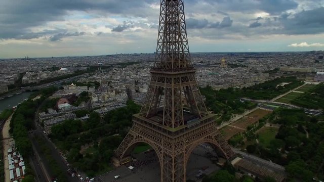 Beautiful aerial drone shot of Eiffel Tower national symbol Paris France Champ de Mars steel monument cloudy cityscape