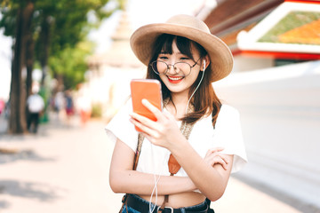 Hipster young asian energetic glasses girl modern style. Listen stream music with smart phone application.